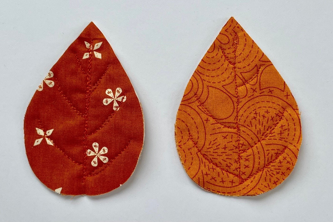 feuilles de tissu rouge et orange sur table blanche