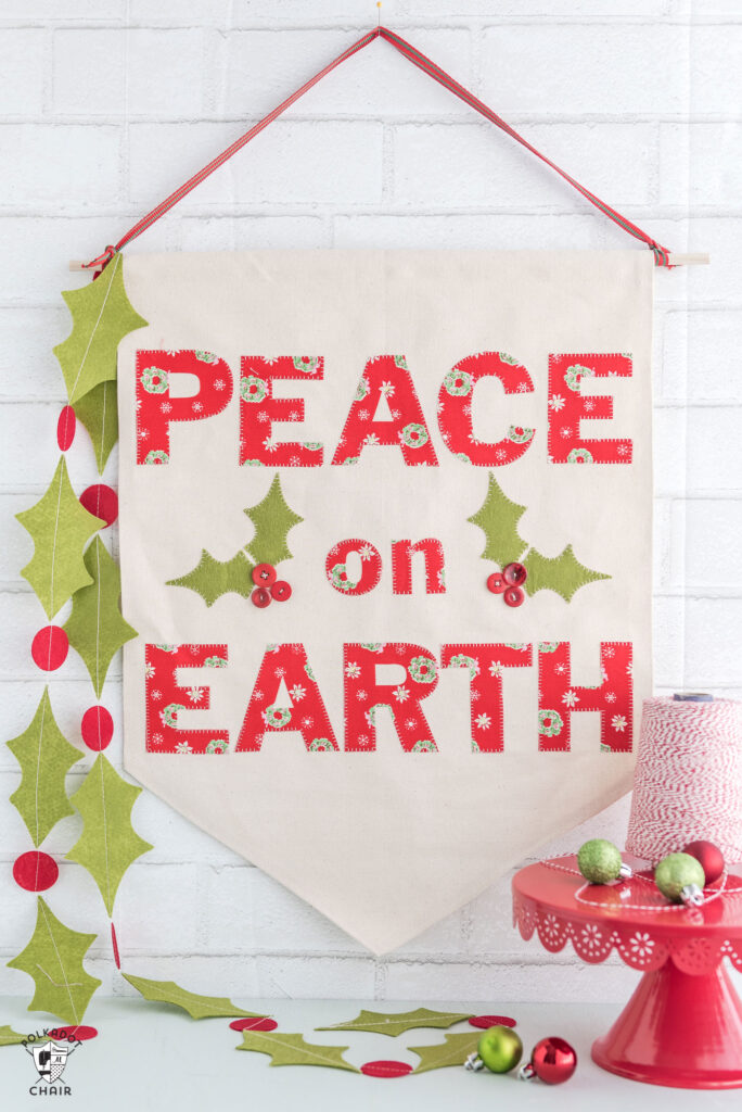 Bannière de noël diy canvas avec motif et modèles gratuits. comment faire une bannière en toile - un joli panneau de noël qui dit "paix sur terre" #christmas #canvasbanner #diy #christmascrafts